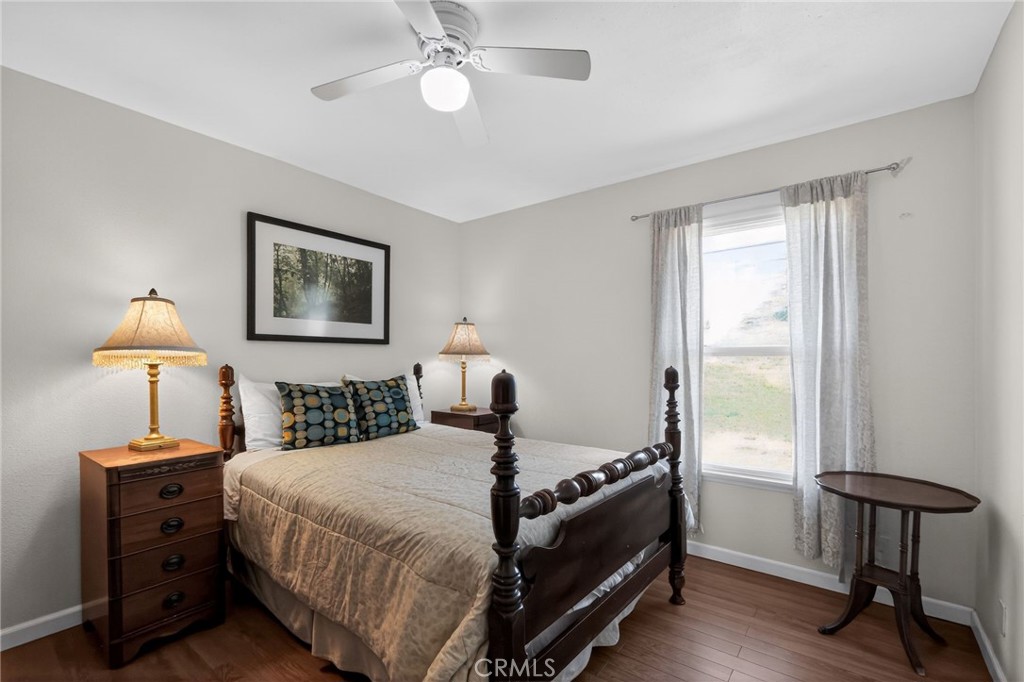 10079 West Lilac Road Escondido, CA 92026 - Photo 21 of 50 a bed room with a bed and a lamp
