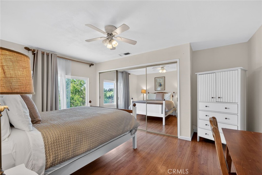 10079 West Lilac Road Escondido, CA 92026 - Photo 22 of 50 a bedroom with a bed and a chandelier