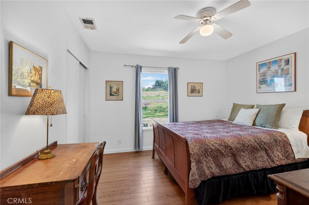 10079 West Lilac Road Escondido, CA 92026 - Photo 24 of 50 a bed room with a bed and a lamp