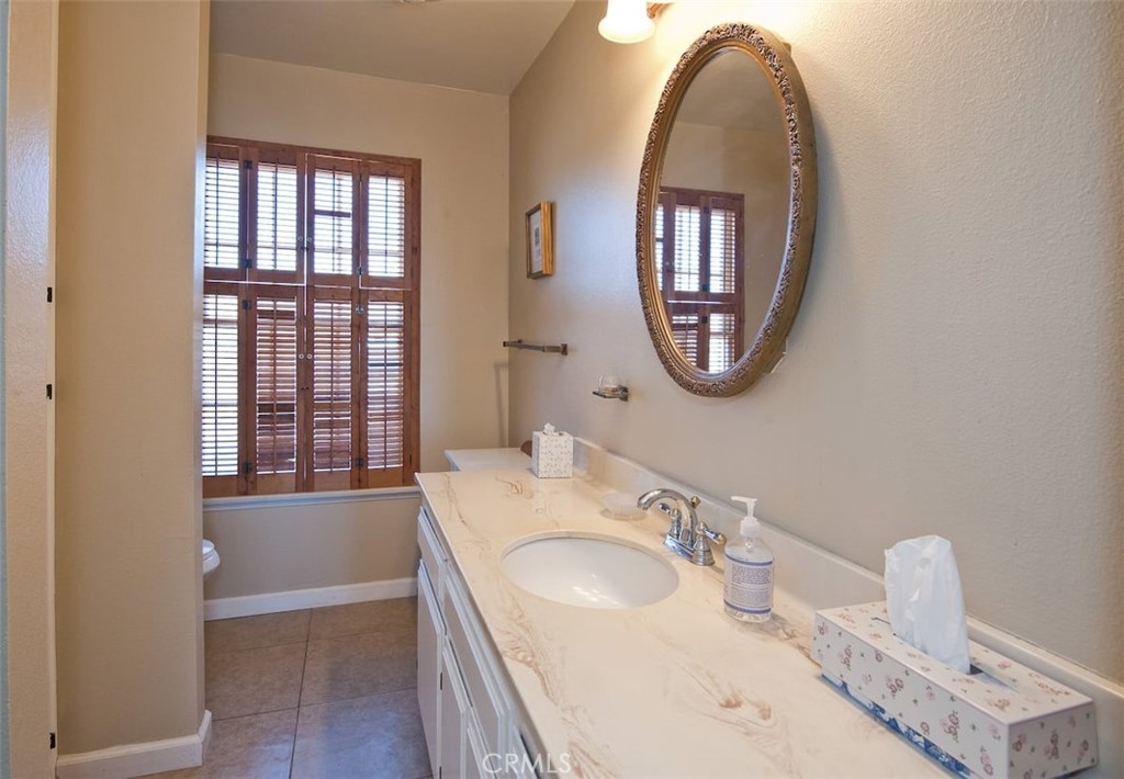 10079 West Lilac Road Escondido, CA 92026 - Photo 25 of 50 a bathroom with a sink and a mirror