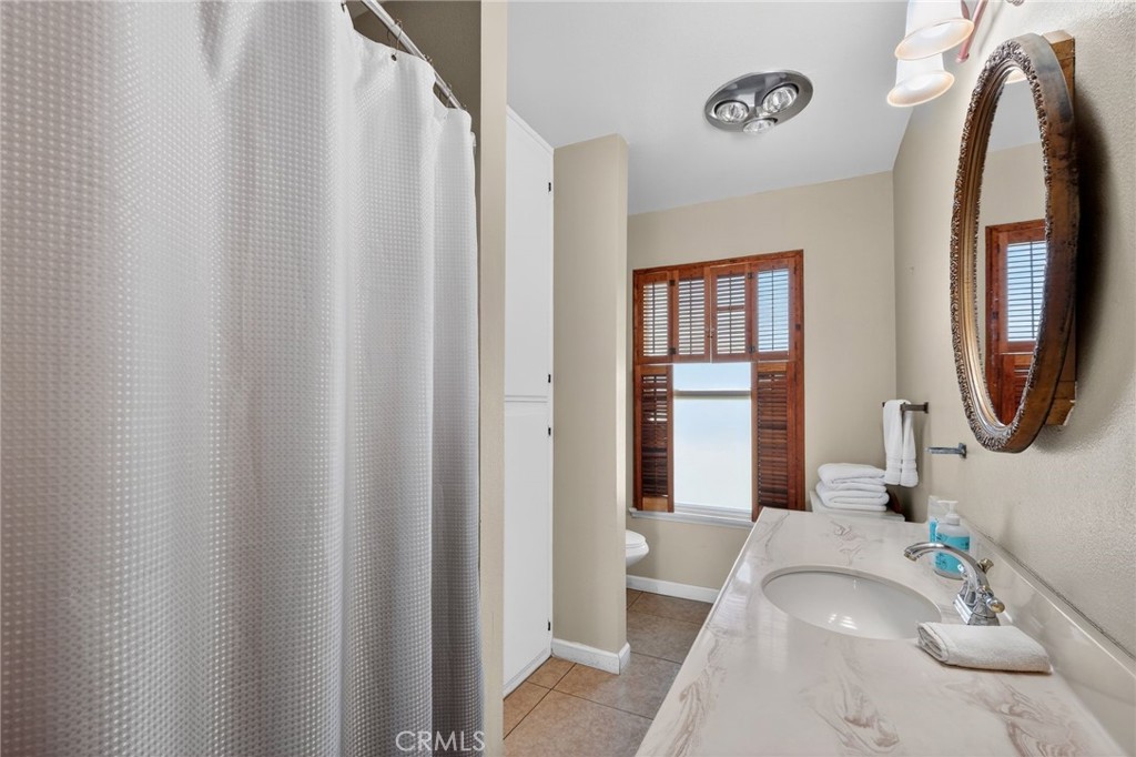 10079 West Lilac Road Escondido, CA 92026 - Photo 26 of 50 a bathroom with a sink and a mirror