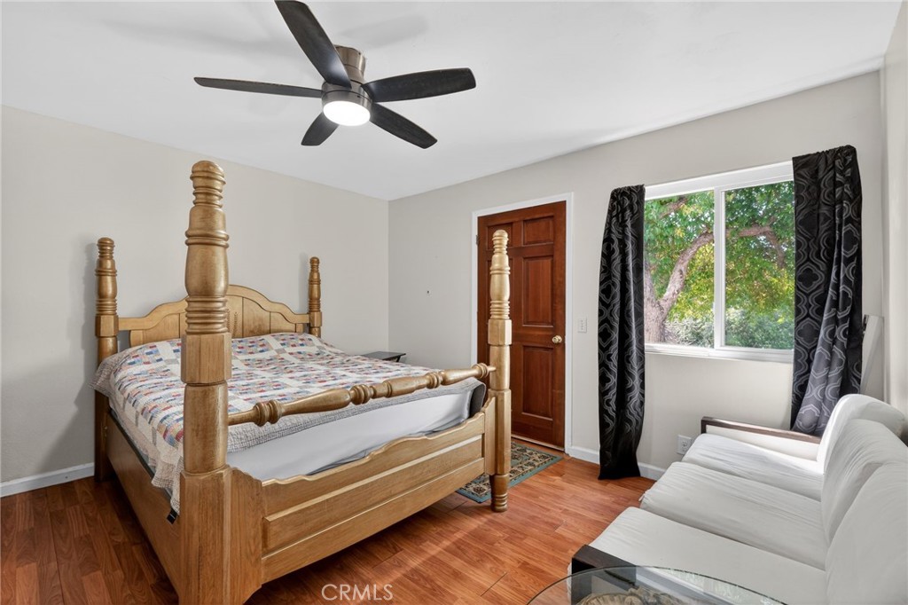 10079 West Lilac Road Escondido, CA 92026 - Photo 27 of 50 a bedroom with a bed and a chandelier
