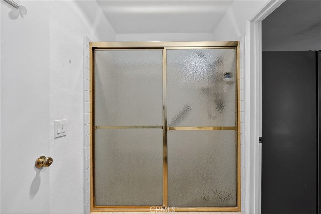 10079 West Lilac Road Escondido, CA 92026 - Photo 29 of 50 a bathroom with a glass shower door