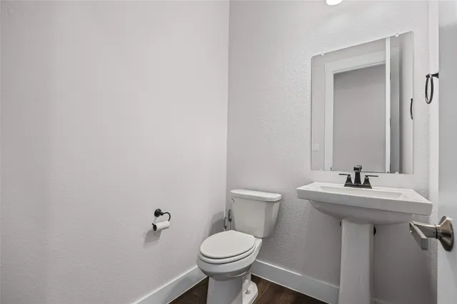 a bathroom with a sink toilet and a mirror