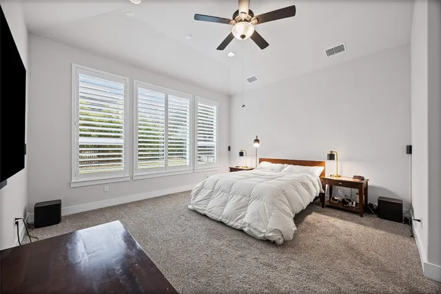 a spacious bedroom with a bed and a window