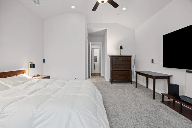 a bedroom with a bed and flat screen tv