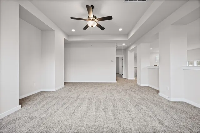 wooden floor in an empty room with a ceiling fan