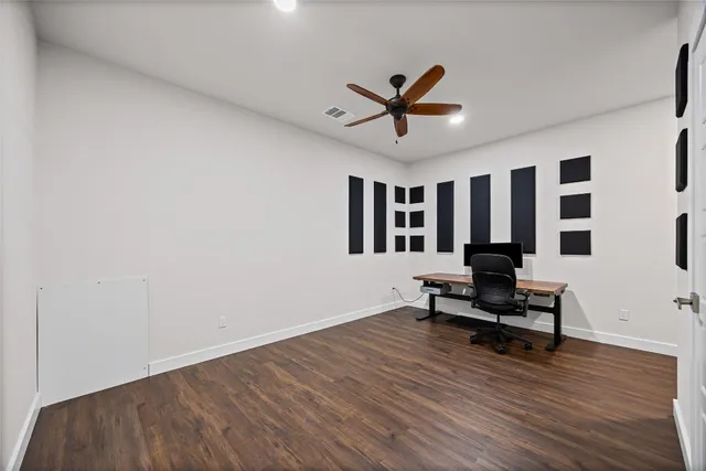 a view of living room with wooden floor and white walls