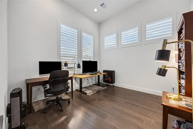 a view of a workspace with furniture and a window