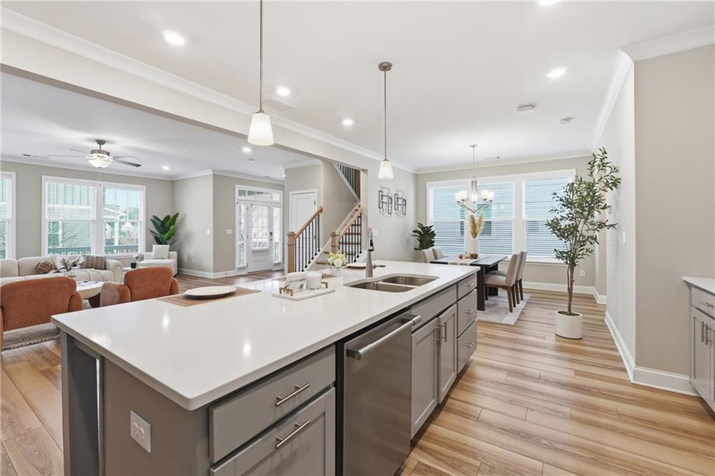 4183 Valtek Court Suwanee, GA 30024 - Photo 12 of 46 a kitchen with sink stove and wooden floor