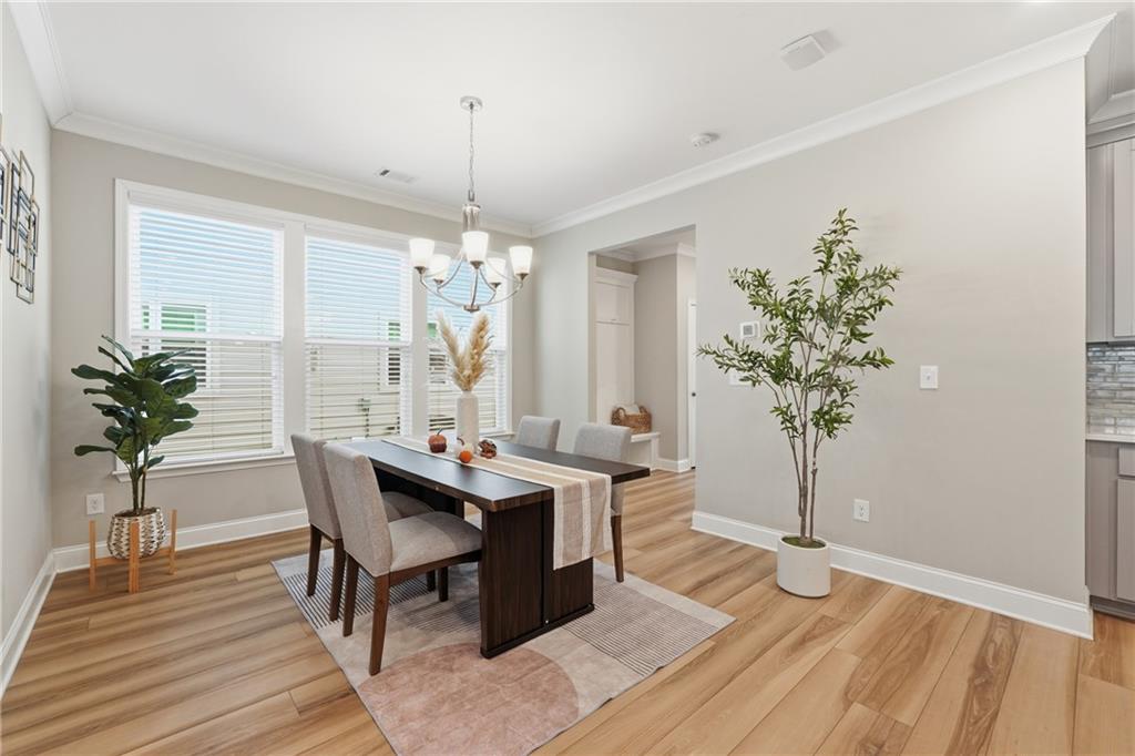 4183 Valtek Court Suwanee, GA 30024 - Photo 14 of 46 a living room with furniture and a chandelier