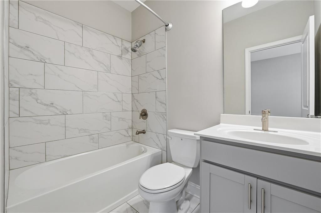 4183 Valtek Court Suwanee, GA 30024 - Photo 28 of 46 a bathroom with a sink a toilet and a bathtub