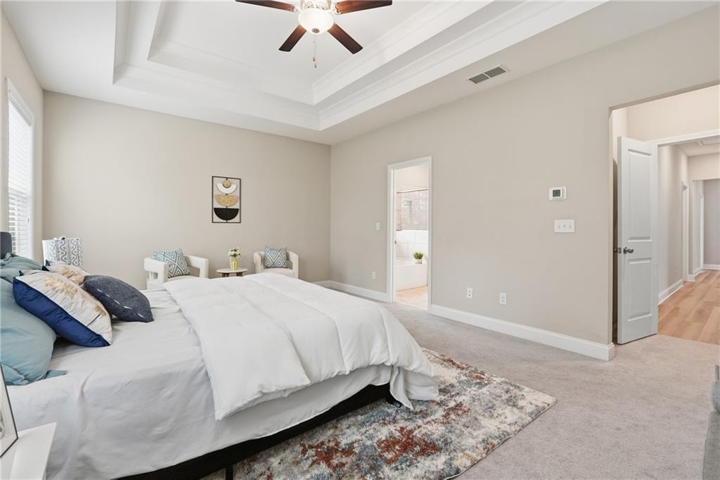 4183 Valtek Court Suwanee, GA 30024 - Photo 30 of 46 a bedroom with a bed and a ceiling fan