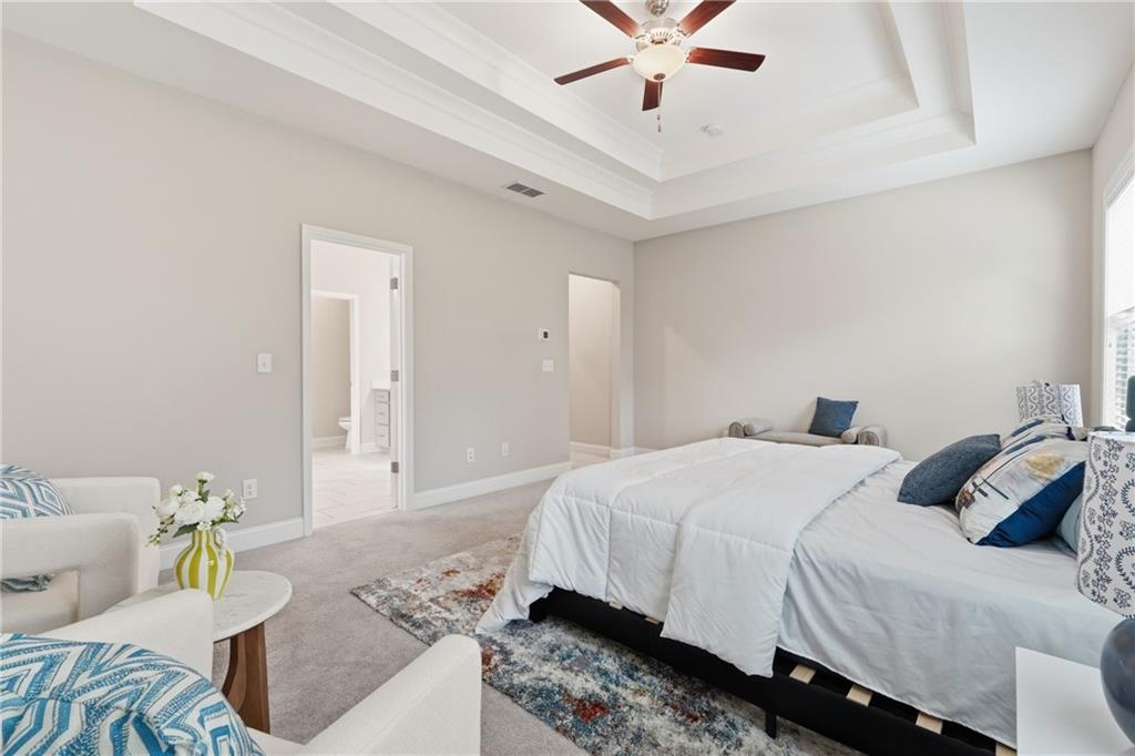 4183 Valtek Court Suwanee, GA 30024 - Photo 32 of 46 a bedroom with a bed and ceiling fan