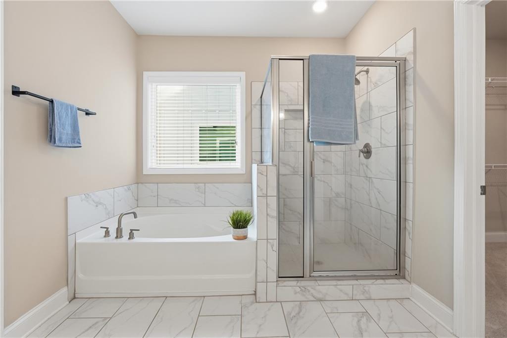 4183 Valtek Court Suwanee, GA 30024 - Photo 34 of 46 a white bath tub sitting next to a shower