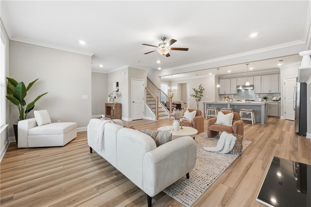 4183 Valtek Court Suwanee, GA 30024 - Photo 8 of 46 a living room with furniture and a view of kitchen