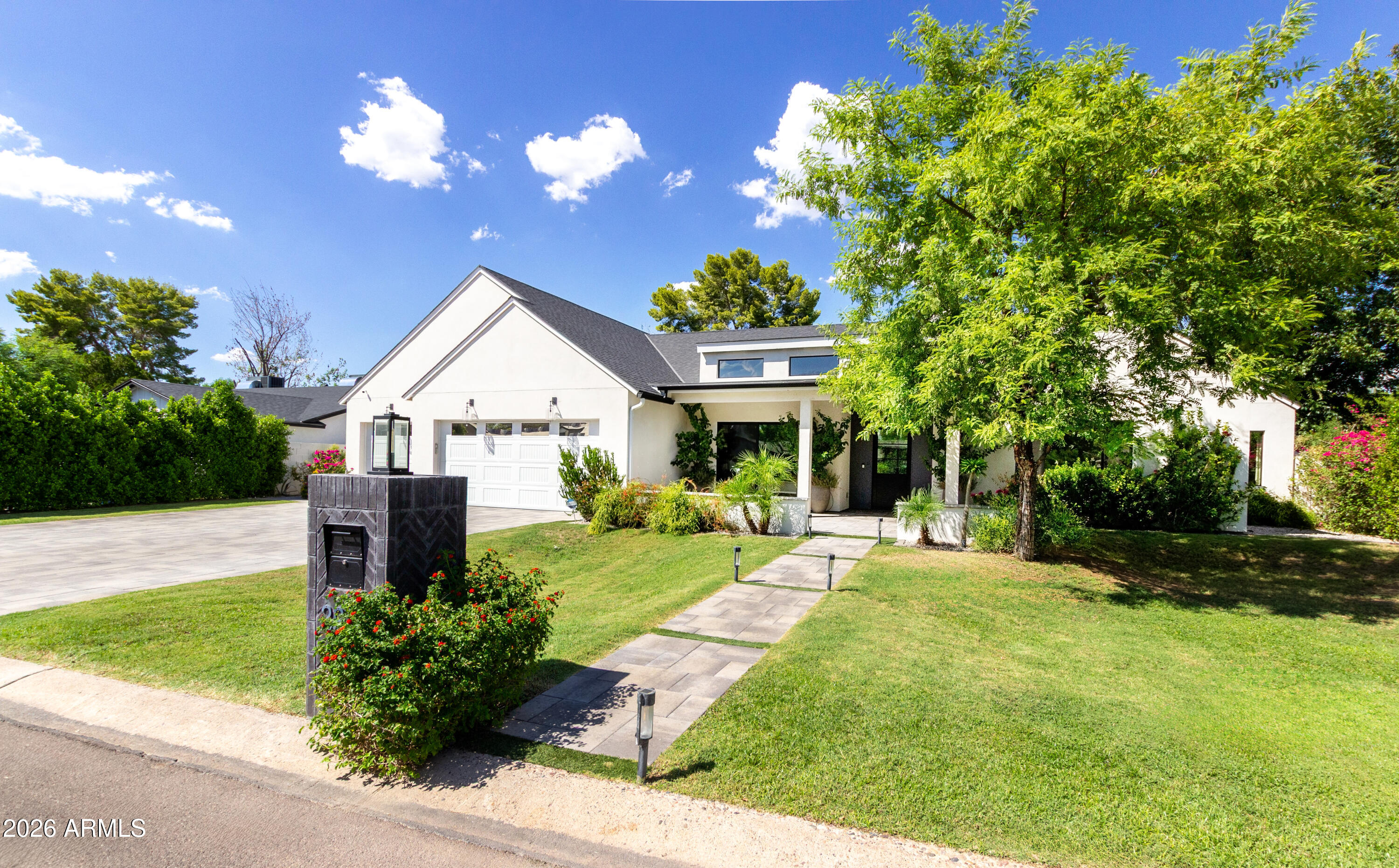 a front view of a house with a yard and porch