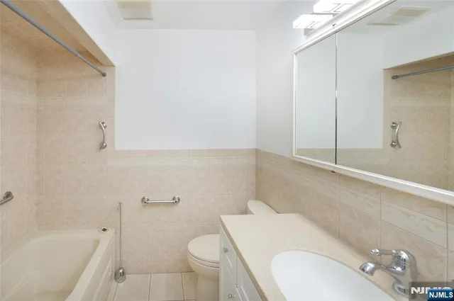 a bathroom with a sink a toilet and bathtub