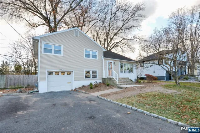 a view of a house with a yard covered in snow