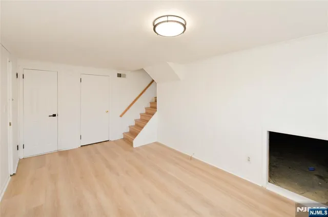 a view of a room with wooden floor