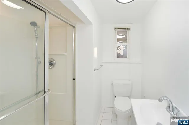 a white toilet sitting next to a bathroom sink