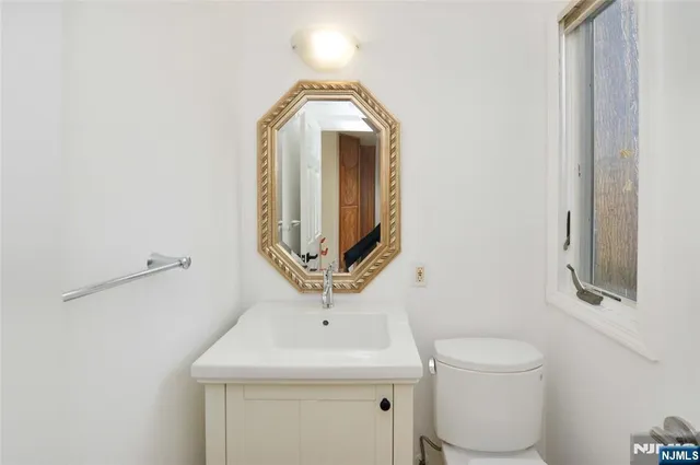 a bathroom with a toilet sink and mirror