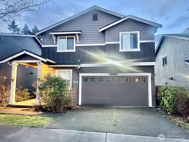 a front view of a house with a yard and garage