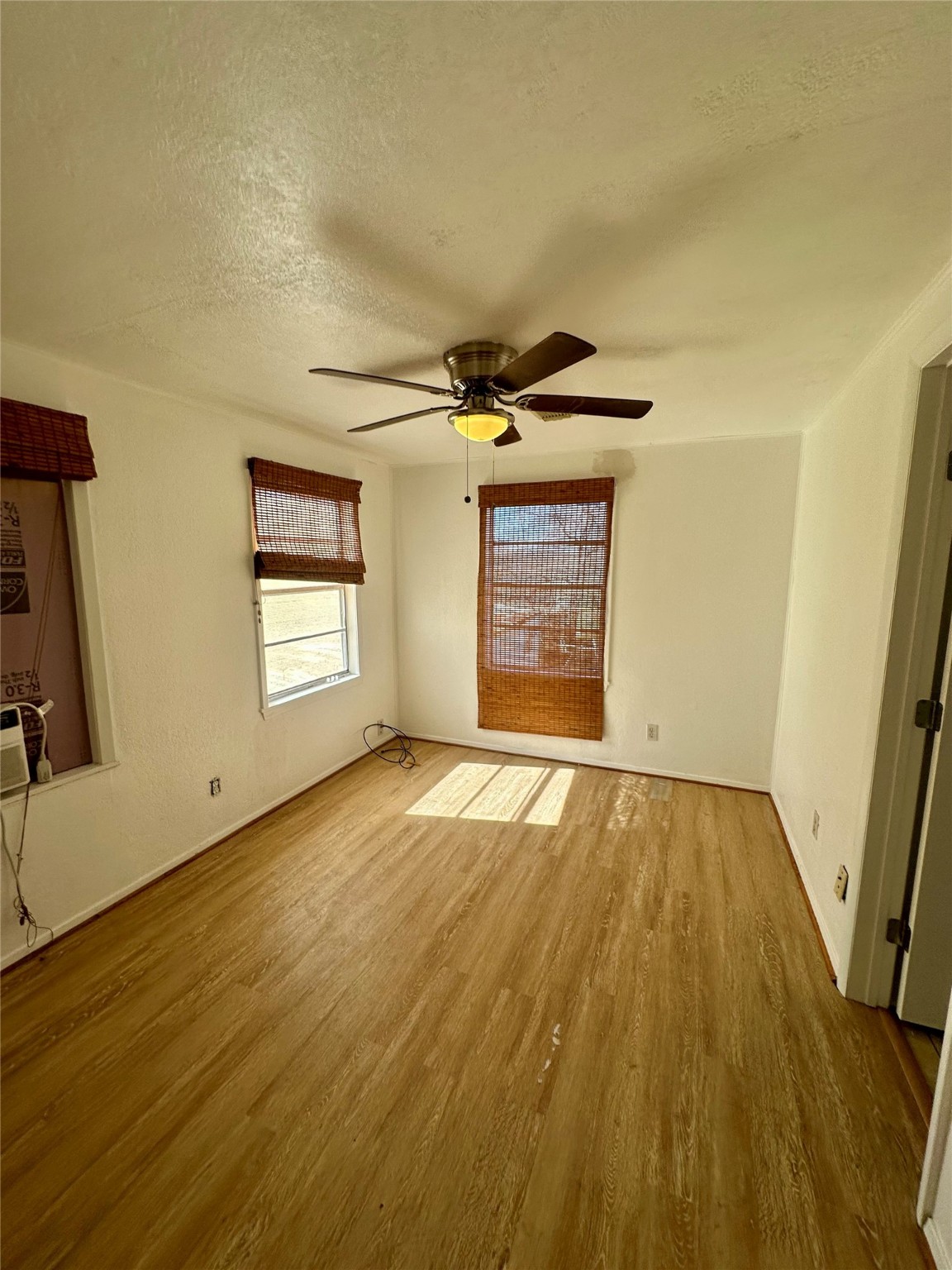124 7th Street Dickinson, TX 77539 - Photo 11 of 19 a view of an empty room with a window and wooden floor