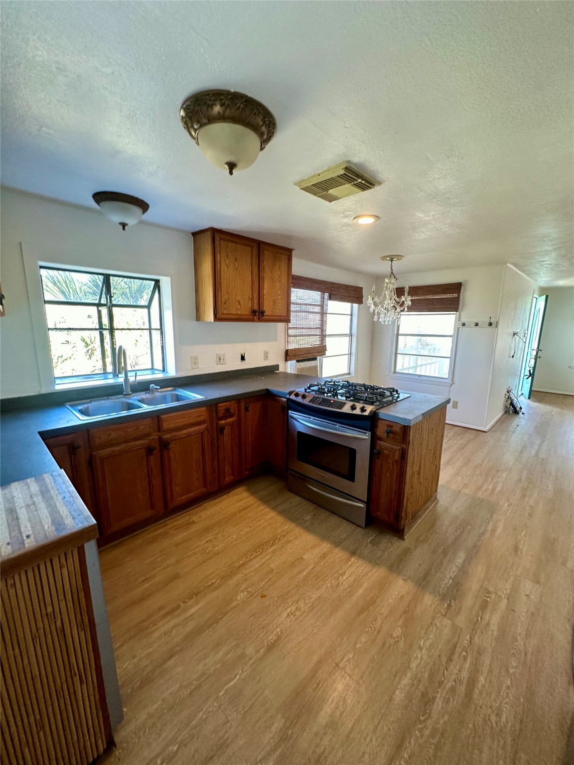 124 7th Street Dickinson, TX 77539 - Photo 3 of 19 a kitchen with stainless steel appliances granite countertop a stove a sink dishwasher and a oven with granite countertops