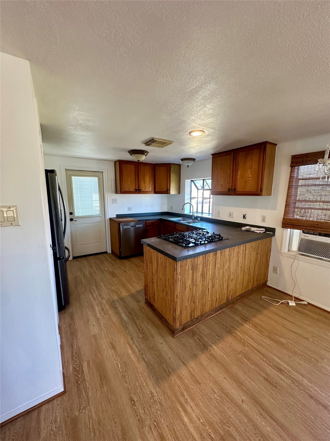 124 7th Street Dickinson, TX 77539 - Photo 4 of 19 a kitchen with stainless steel appliances granite countertop a stove a sink dishwasher and a refrigerator