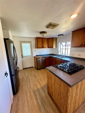 a kitchen with granite countertop a stove and a refrigerator