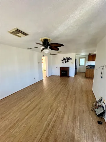 a view of a livingroom with furniture and a ceiling fan
