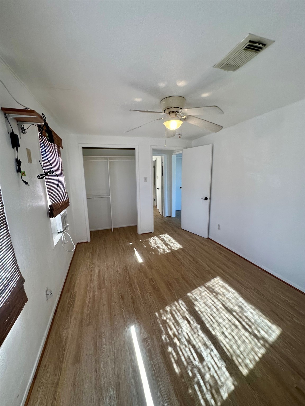 124 7th Street Dickinson, TX 77539 - Photo 9 of 19 wooden floor in an empty room with a fireplace