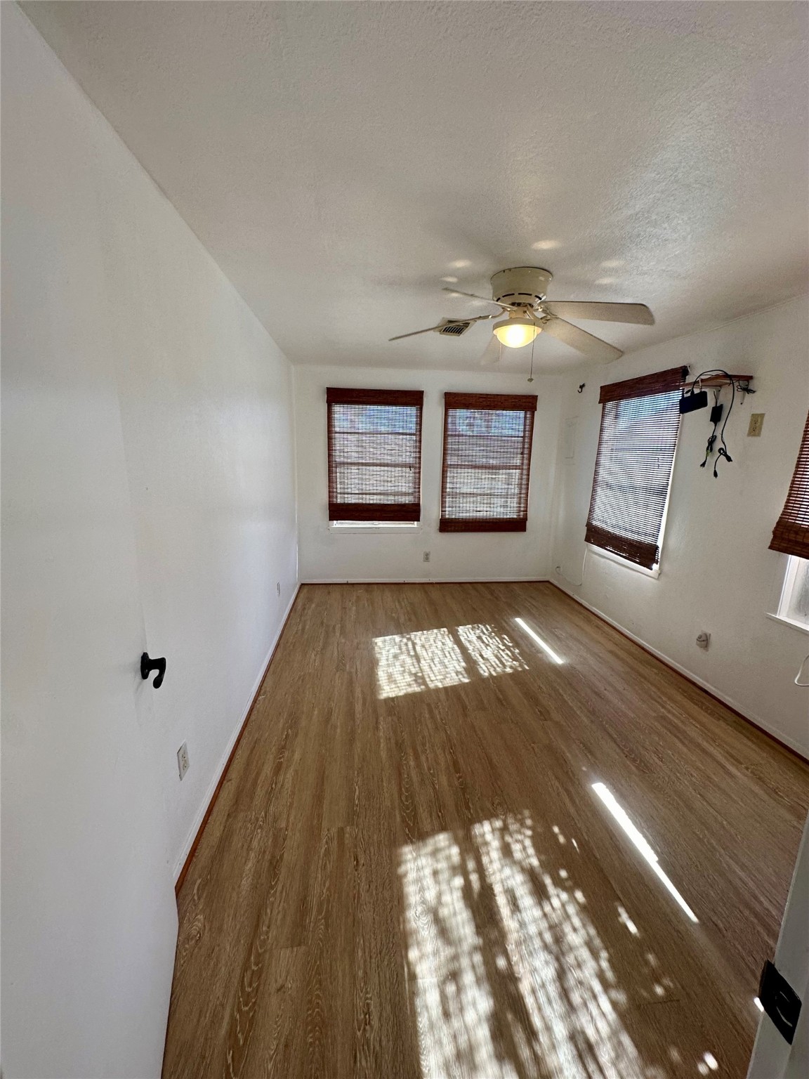 124 7th Street Dickinson, TX 77539 - Photo 10 of 19 wooden floor in an empty room with a window