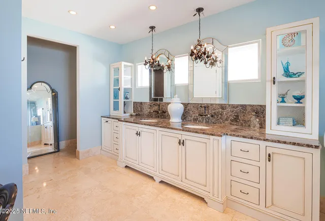 a spacious bathroom with a granite countertop sink a mirror and a shower