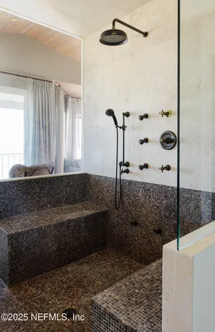 a bathroom with a bathtub and a shower
