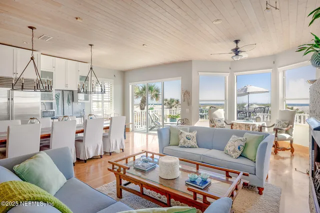 a living room with furniture dining table and a large window