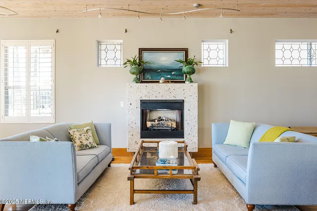 a living room with furniture and a fireplace