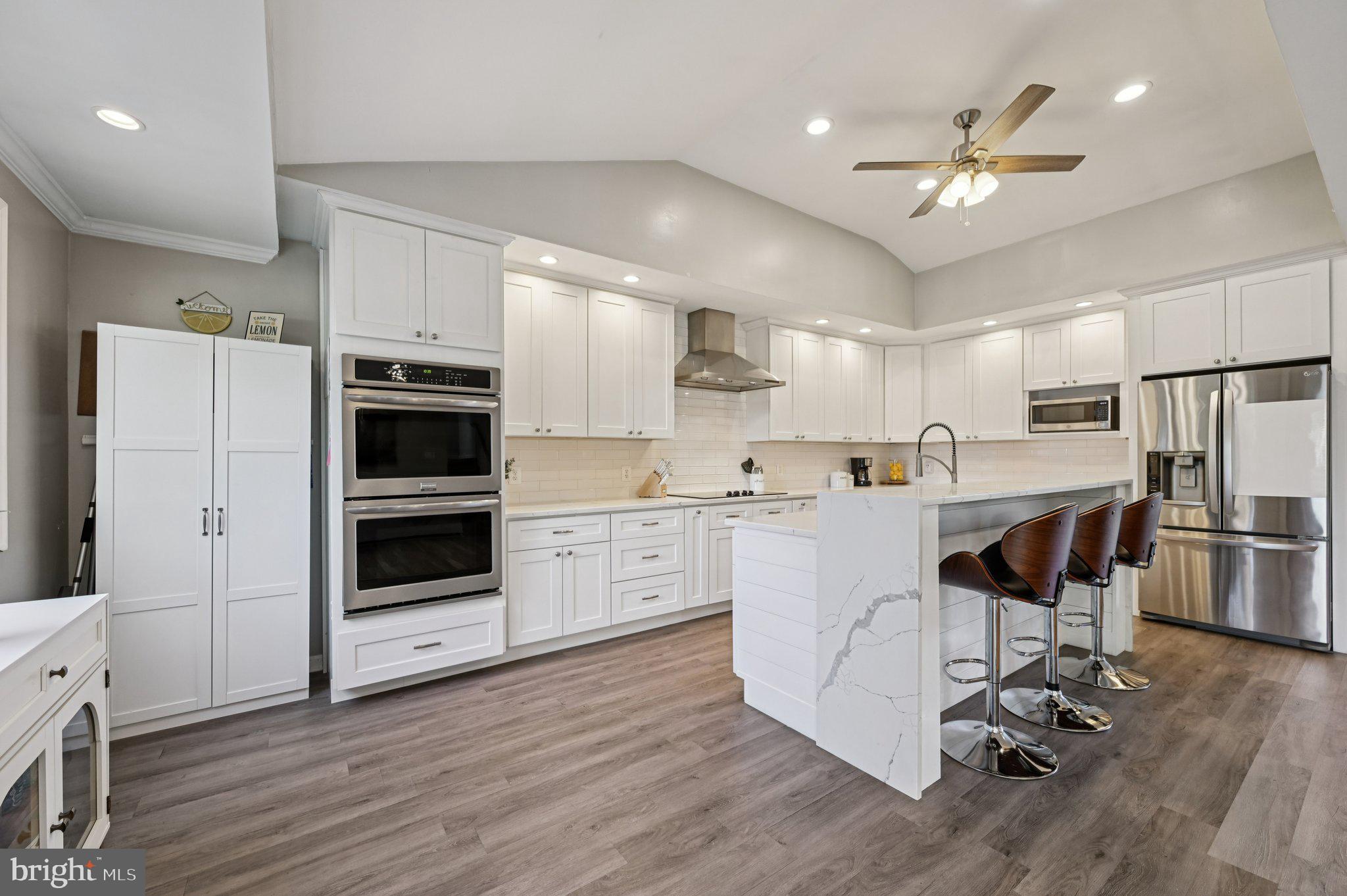3025 Rock Drive Riva, MD 21140 - Photo 11 of 48 a kitchen with kitchen island white cabinets and stainless steel appliances