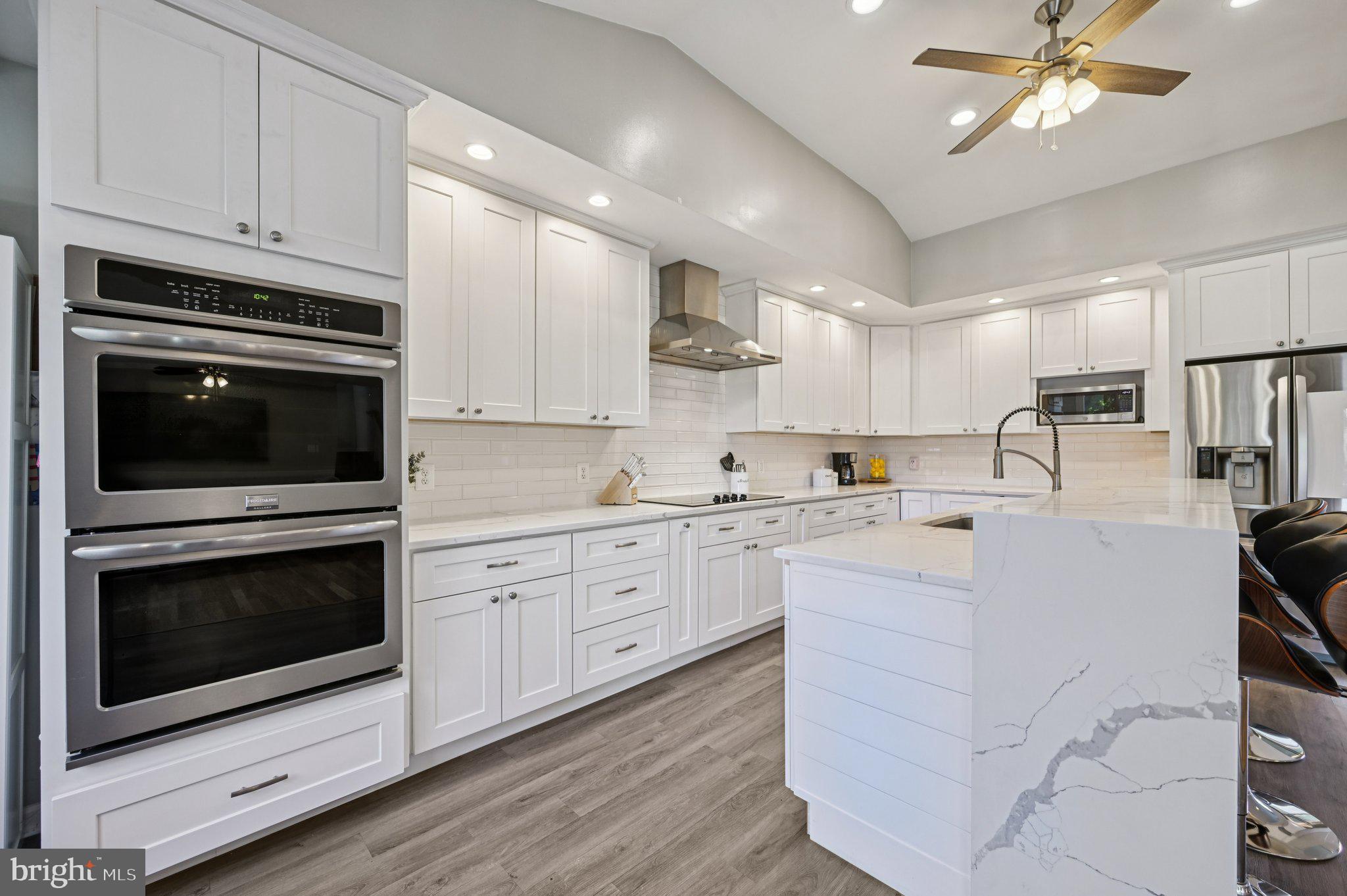 3025 Rock Drive Riva, MD 21140 - Photo 14 of 48 a kitchen with granite countertop white cabinets white stainless steel appliances and sink