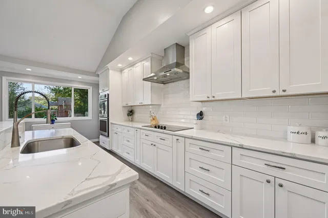 a kitchen with white cabinets and white appliances