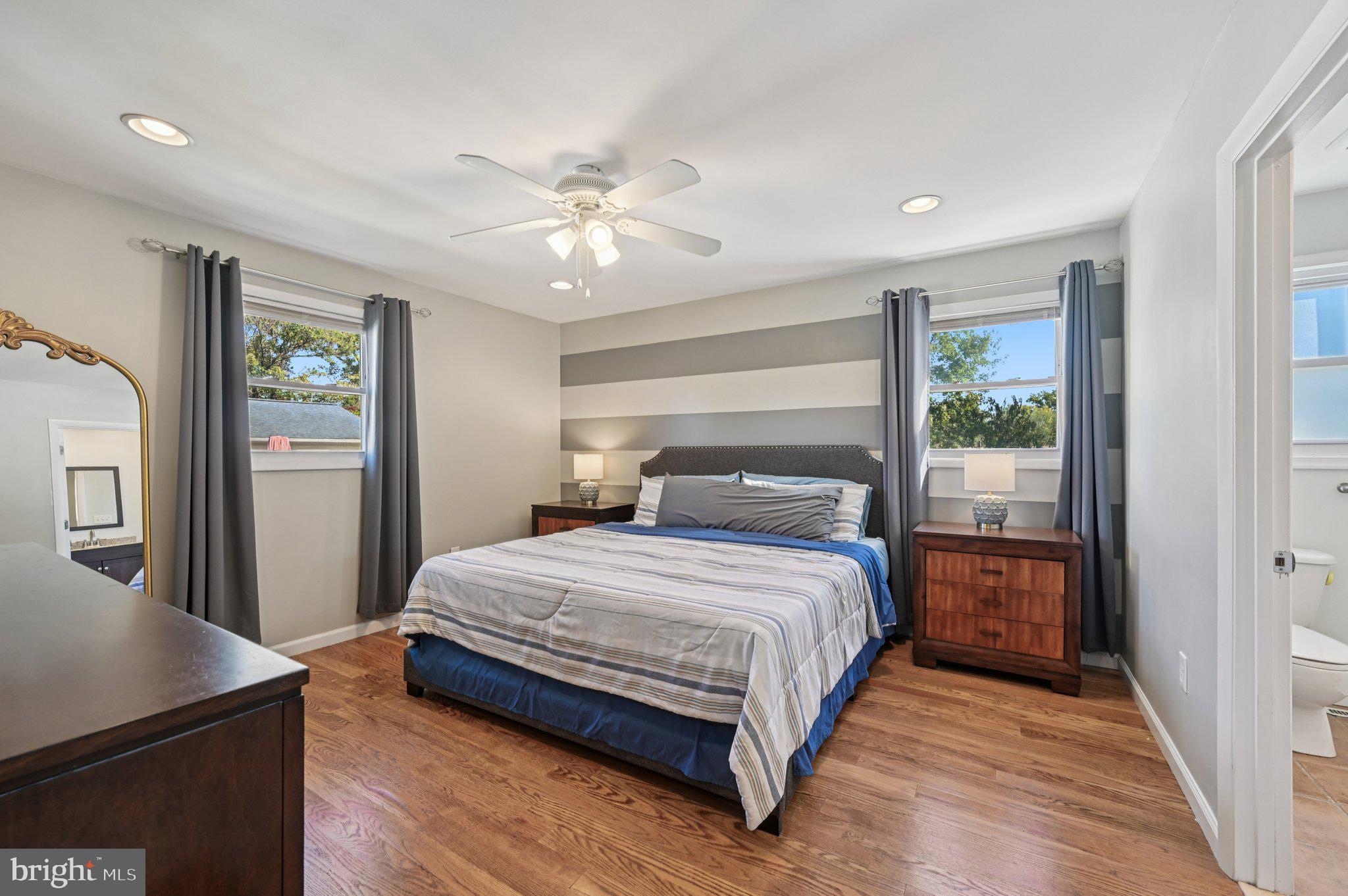 3025 Rock Drive Riva, MD 21140 - Photo 18 of 48 a bedroom with a large bed and a chandelier