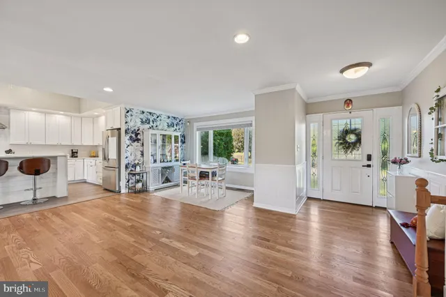 a view of a living room kitchen and a wooden floor