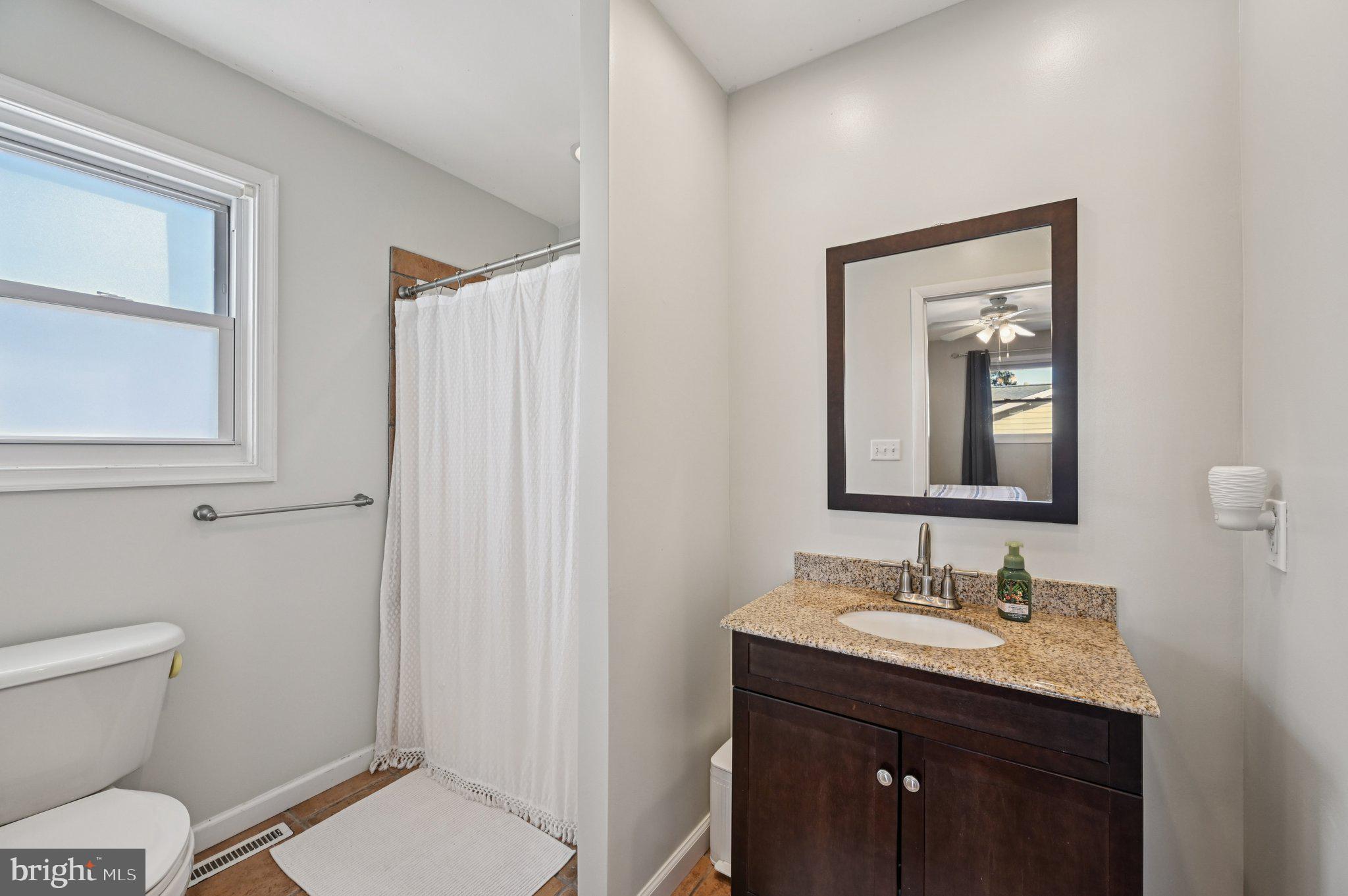 3025 Rock Drive Riva, MD 21140 - Photo 23 of 48 a bathroom with a granite countertop sink toilet and shower