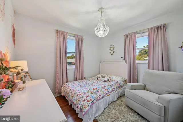 a bedroom with a bed couch and window