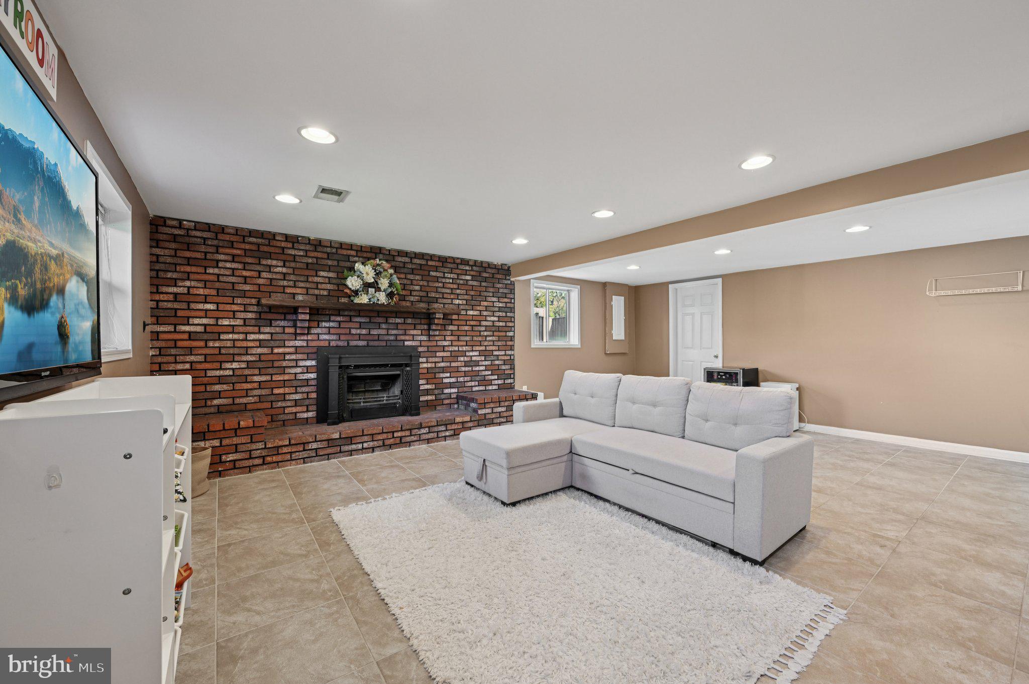 3025 Rock Drive Riva, MD 21140 - Photo 32 of 48 a living room with furniture a fireplace and a flat screen tv
