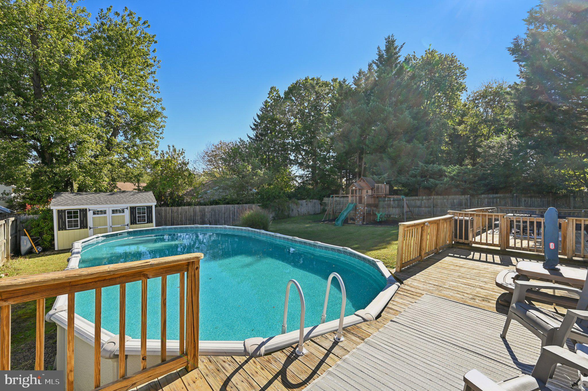 3025 Rock Drive Riva, MD 21140 - Photo 44 of 48 a view of a deck with couches chairs and wooden floor next to a yard