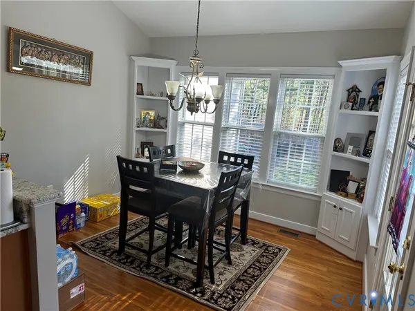 a view of a dining room with furniture window and wooden floor