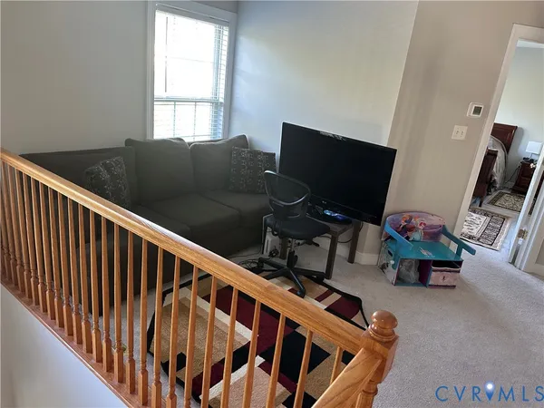 a view of entryway with wooden floor and stairs