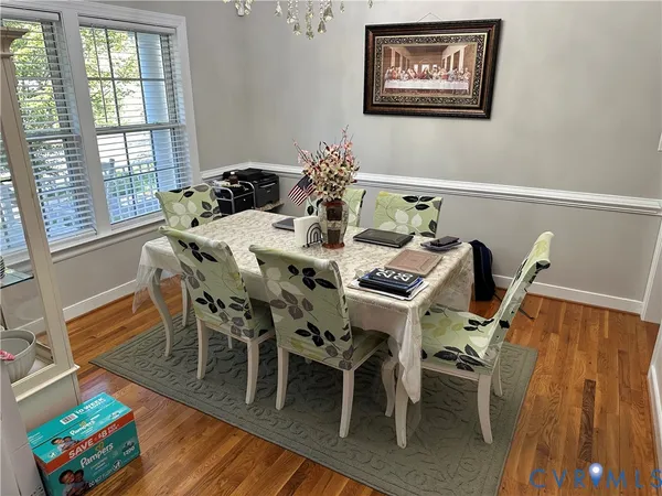 a view of a dining room with furniture and wooden floor
